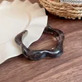 Retro Maillard style irregular wide resin bangle with translucent smoke amber pattern detail - Black