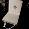Detailed view of elegant multi-layer pearl waist chain with vintage decorative centerpiece - Style 19