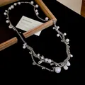 Close-up of vintage multi-layer pearl waist chain with shell and star pendant details - 27# Style