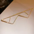 Detailed macro view of gold metal rhinestone glasses frame with unique lightning bolt design - Wave Lightning Style