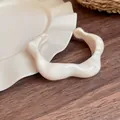Elegant irregular cream resin cuff bracelet with a vintage marble texture. - Off White