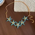 Retro bohemian gold waist chain with five blue enamel starfish charms for beach dresses. - Style 40