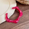 Irregular wide resin bangle in magenta marble finish with unique wavy wave design - Rose Red