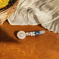 Detailed close-up of a sweet resin hair clip with blue crystal and LUCKY engraving - Blue-Coffee Brown (Single) / Silver