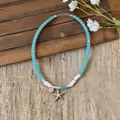Detail view of summer starfish and seashell charms on blue beaded necklace chain - Starfish Conch Choker Beaded Necklace