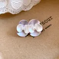 Detailed close-up showing elegant purple and white layered pearl flower earrings on paper - Silver Needle / Purple