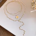 Detailed view of layered pearl and enamel flower necklace in elegant gold finish - Gold-White-Yellow
