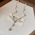 Vue macro d'un élégant collier de perles de style français avec pendentif fleur zircon. - Argent-Rose