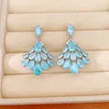 Close-up detail of fan-shaped chandelier earrings with light blue pear-cut zirconia stones. - 14k Gold Plated Tassel Style (HE34194) / Gold (Blue Zircon)