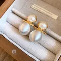 Detailed macro view of 18k gold plated stud earrings with pearls and brushed silver beads - Silver Earring Post Style / Silver