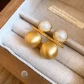 Detailed view of 18k gold plated brushed earrings with elegant white pearl accents - Silver Earring Post Style / Gold