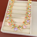 Close-up of luxury vintage palace style necklace with oval zirconia and teal enamel inlay - Necklace / Gold/Pink/Lavender