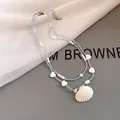 Detailed view of beach-themed double-layer necklace with blue beads and seashell pendant - Blue/White