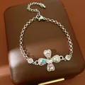 Elegant silver-toned chain bracelet featuring a heart-shaped cross with multi-color zircons - Alloy Bracelet