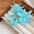 Close-up detail of light blue fabric flower earrings with pearls in a jewelry tray - Sky Blue