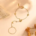 Detailed close-up of a gold-plated butterfly slave bracelet made of durable titanium steel - Sandblasted Hollow Butterfly Hand Chain (O712) / Gold