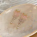 Detailed view of gold fringe tassel earrings with pink and clear crystal beads. - Silver Earring Post Style / Gold-Pink