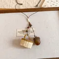 Detail of rustic acorn and miniature woven basket pendant on a brown cord necklace. - Rattan Mini Basket Style (2#)