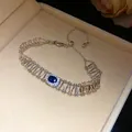 Detailed macro view of vintage hollow bracelet with blue oval zircon centerpiece - Silver Blue