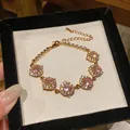 Elegante bracciale placcato oro con pietre rosa tonde e zirconi - Stile Rotondo / Oro-Rosa