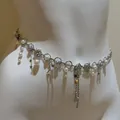 Detailed view of silver star waist chain with faux pearls and rhinestones on mannequin - Silver