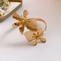 Detailansicht des filigranen goldfarbenen Blumendesigns dieses Vintage-Armreif-Armbands - Gold