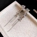 Close-up of vintage silver wheat spike tassel clip-on earrings with sparkling zircon details - Clip-On Earrings / Silver
