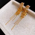 Detailed close-up of vintage gold wheat ear tassel clip-on earrings with zircon accents - Clip-On Earrings / Gold