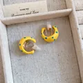 Detail of yellow polka dot C-shaped clip-on earrings presented in a jewelry box - Clip-on Earrings / Non-Pierced Design / Milk Yellow