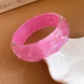 Close-up detail of iridescent pink resin bangle with unique wrinkled texture. - Translucent Bright Pink Pleated Texture / No. 5 Bangle - Iridescent Lavender