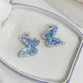 Close-up of blue butterfly earrings with sparkling zircon borders in a jewelry box - Clip-on Silver Light Blue (One Pair)