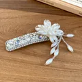 Detailed view of an elegant hair clip with pearl flowers and sparkling crystals. - Snap Clip (Single)