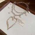 Close-up of vintage silver double-layer necklace with baroque pearls and heart pendant. - Silver