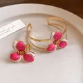 Detailed view of an elegant pink enamel flower ring and open cuff bracelet jewelry set - Bracelet and Ring Set / Rose Red