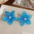 Elegant blue fabric flower stud earrings featuring a pearl center for a vacation look - Flower Style / Blue