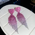 Macro view of glamorous gradient pink heart-shaped earrings with long rhinestone tassels - Peach Heart Gradient Pink Tassel Style (18#)
