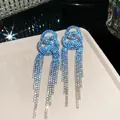 Detailed macro view of elegant blue rhinestone tassel earrings with sparkling starbursts - Triple Ring Gradient Tassel Style (25#)
