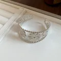 Detailed view of silver metal flower cuff bracelet with elegant beaded edge detailing. - Five-Petal Pleated Flower Style / Silver