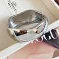 Close-up of a chunky silver wavy metal bangle featuring a polished mirror finish detail - Wavy Mirror Wide Style / Silver