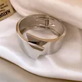 Close-up detail of a silver wide metal cuff bracelet featuring geometric layered design - Stereo Crisscross Geometric Style / Silver