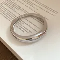 Detailed view of a silver chunky metal hinged bangle with a high-polished mirror finish - Thickened Ring Hinge Style / Silver