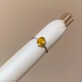 Close-up view of a vintage minimalist silver ring with a vibrant oval yellow gemstone. - Square Open Ring (HR3582) / Yellow