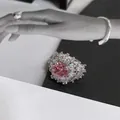 Detailed view of a luxury pink square zircon flower ring with sparkling white accents - Silver with Pink Crystal