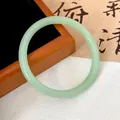 Macro detail of a light green translucent glass bangle with smooth round profile. - Light Green (Style 10)