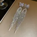 Elegant silver needle earrings with shimmering rhinestone bow and cascading long tassels - Bowknot Rhinestone Tassel Style (83#)