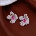 Dettaglio ravvicinato di un elegante anello a fiore in oro 18k con zirconi rosa. - Stud orecchini / Argento-Rosa