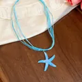 Close-up of a blue resin starfish pendant necklace with multi-strand ribbon cords - Blue