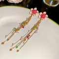 Close-up of pink enamel flower tassel earrings with pearls for a summer vacation look - Pink Flower Tassel (HE34240) / Silver Needle / Gold