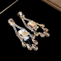 Elegant silver tassel earrings with clear sparkling crystals and teardrop pendants. - Rhombus Teardrop Tassel Style (77#)