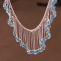 Detailed close-up of a French style silver lace tassel necklace with light blue beads - Hollow Lace Tassel (RB-1689) / Blue